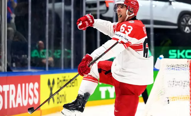 Denmark's Patrick Russell celebrates after scoring his side's third goal during the 2026 IIHF Men's Ice Hockey World Championship preliminary round group B match between Norway and Denmark in Fribourg, Switzerland, Tuesday, May 26, 2026. (Laurent Gillieron/Keystone via AP)