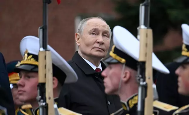 Russian President Vladimir Putin, centre foreground, attends a ceremony to lay flowers at the Tomb of the Unknown Soldier by the Kremlin wall inMoscow, Saturday, May 9, 2026, during celebrations of the 81st anniversary of the Soviet Union's victory over Nazi Germany during the World War II. (Alexander Nemenov/Pool Photo via AP)