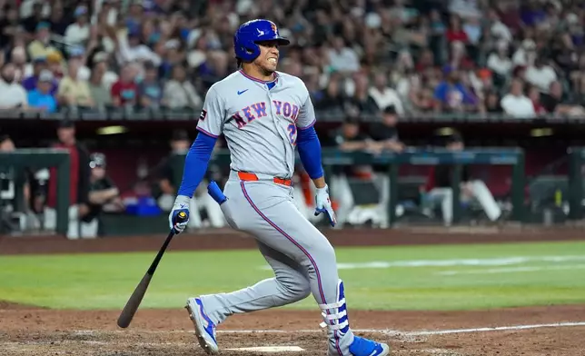 New York Mets' Juan Soto grimaces after a swinging strike during the eighth inning of a baseball game against the Arizona Diamondbacks, Saturday, May 9, 2026, in Phoenix. (AP Photo/Ross D. Franklin)