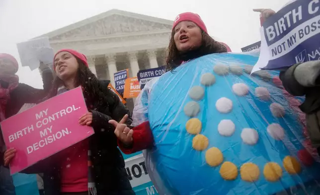 FILE - Margot Riphagen of New Orleans, La., wears a birth control pill costume during a protest in front of the U.S. Supreme Court in Washington, March 25, 2015. (AP Photo/Charles Dharapak, File)