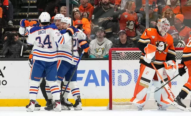 Edmonton Oilers defenseman Connor Murphy, second from left, celebrates his goal with teammates as Anaheim Ducks goaltender Lukas Dostal stands in goal during the first period of Game 6 in the first round of the NHL hockey Stanley Cup playoffs series Thursday, April 30, 2026, in Anaheim, Calif. (AP Photo/Mark J. Terrill)