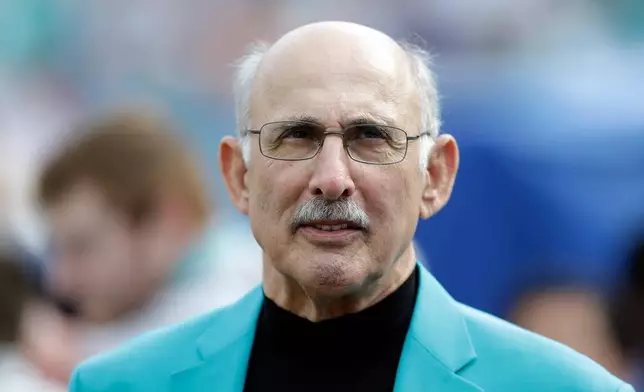 FILE - Former Miami Dolphins player Manny Fernandez waits to be inducted into the team's honor roll during half time of an NFL football game against the Minnesota Vikings, Dec. 21, 2014, in Miami Gardens, Fla. (AP Photo/Wilfredo Lee, File)
