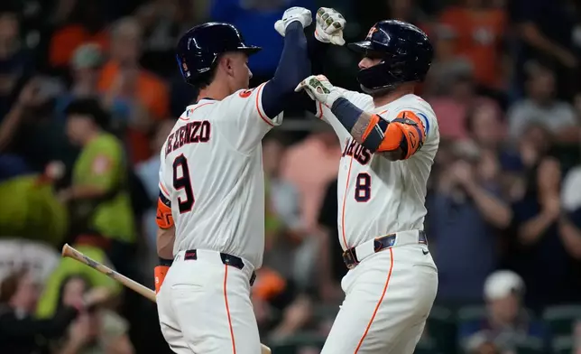 Houston Astros' Christian Walker (8) celebrates with Zach Dezenzo after hitting a home run during the fifth inning of a baseball game against the Seattle Mariners in Houston, Wednesday, May 13, 2026. (AP Photo/Ashley Landis)