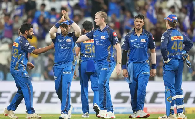 Mumbai Indians' Corbin Bosch celebrates with teammates the wicket of Lucknow Super Giants' Mitchell Marsh during the Indian Premier League cricket match between Mumbai Indians and Lucknow Super Giants in Mumbai, India, Monday, May 4, 2026.(AP Photo/Rafiq Maqbool)