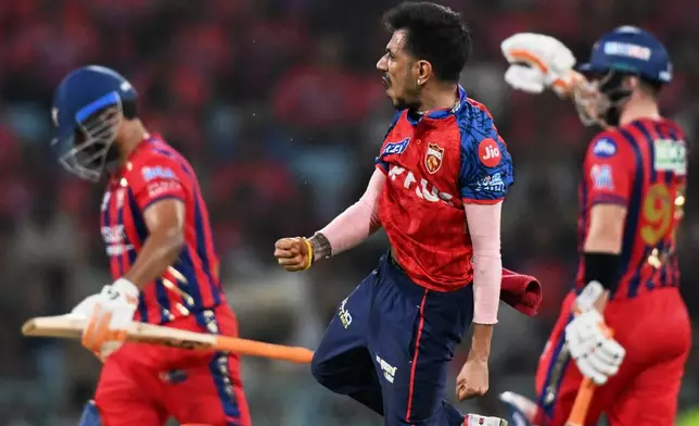 Punjab Kings' Yuzvendra Chahal, centre, celebrates the wicket of Lucknow Super Giants' captain Rishabh Pant, left, during the Indian Premier League cricket match between Lucknow Super Giants and Punjab Kings, in Lucknow, India, Saturday, May 23, 2026. (AP Photo)