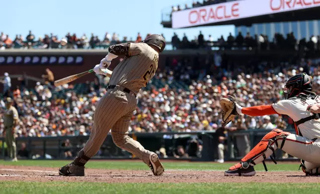 San Diego Padres' Ty France (25) hits a two-run triple in front of San Francisco Giants catcher Patrick Bailey, right, during the seventh inning of a baseball game in San Francisco, Wednesday, May 6, 2026. (AP Photo/Jed Jacobsohn)