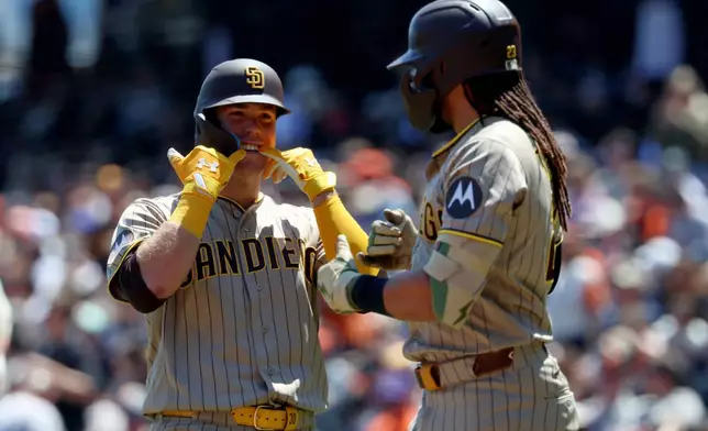 San Diego Padres' Gavin Sheets, left, celebrates with Fernando Tatis Jr., right, after hitting a home run against the San Francisco Giants during the fourth inning of a baseball game in San Francisco, Wednesday, May 6, 2026. (AP Photo/Jed Jacobsohn)