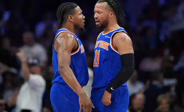 New York Knicks' Miles McBride, left, and Jalen Brunson celebrate during the first half of Game 4 against the Philadelphia 76ers in a second-round NBA basketball playoffs series Sunday, May 10, 2026, in Philadelphia. (AP Photo/Matt Slocum)