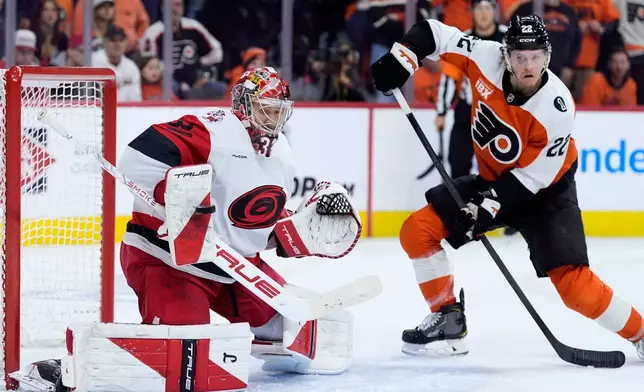 Carolina Hurricanes' Frederik Andersen, left, blocks a shot past Philadelphia Flyers' Christian Dvorak during the second period of Game 3 in the second round of the NHL hockey Stanley Cup playoffs, Thursday, May 7, 2026, in Philadelphia. (AP Photo/Matt Slocum)