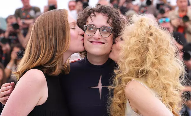 Hannah Einbinder, from left, director Jane Schoenbrun and Gillian Anderson pose for photographers at the photo call for the film 'Teenage Sex and Death at Camp Miasma' during the 79th international film festival, Cannes, southern France, Wednesday, May 13, 2026. (AP Photo/Andreea Alexandru)