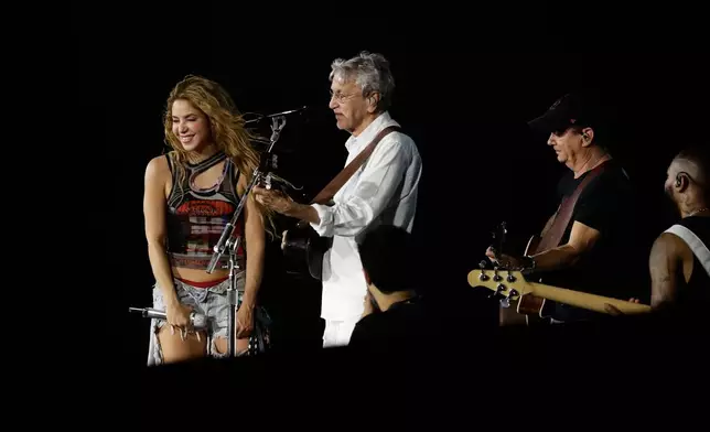 Colombian singer Shakira and Brazilian singer Caetano Veloso, second left, take part in a rehearsal a day ahead of Shakira's free concert, on Copacabana beach, in Rio de Janeiro, Friday, May 1, 2026. (AP Photo/Bruna Prado)