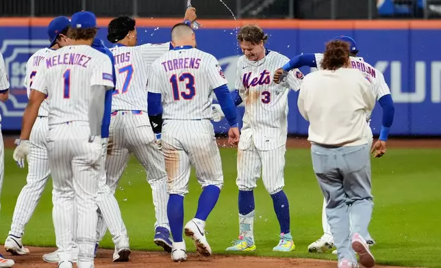 New York Mets' Carson Benge (3) celebrates with teammates after hitting a walk-off RBI single during the tenth inning of a baseball game against the Detroit Tigers, Wednesday, May 13, 2026, in New York. (AP Photo/Yuki Iwamura)
