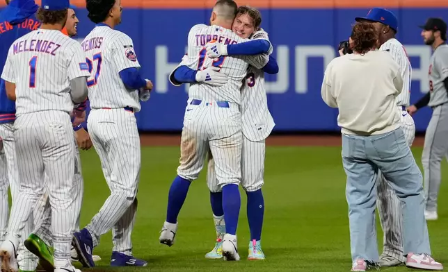New York Mets' Carson Benge (3) celebrates with New York Mets' Luis Torrens after hitting a walk-off RBI single during the tenth inning of a baseball game against the Detroit Tigers, Wednesday, May 13, 2026, in New York. (AP Photo/Yuki Iwamura)
