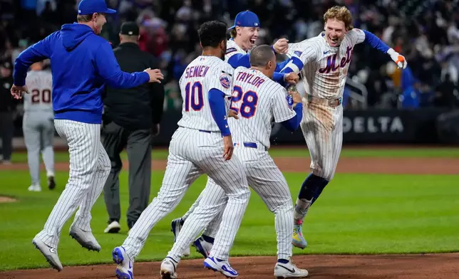 New York Mets' Carson Benge (3), right, celebrates with teammates after hitting a walk-off RBI single during the tenth inning of a baseball game against the Detroit Tigers, Wednesday, May 13, 2026, in New York. (AP Photo/Yuki Iwamura)