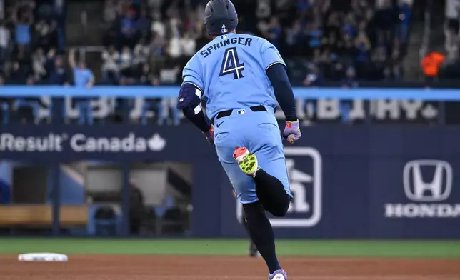Toronto Blue Jays' George Springer (4) runs the bases after hitting a solo home run against the Pittsburgh Pirates during the first inning of a baseball game in Toronto, Saturday, May 23, 2026. (Jon Blacker/The Canadian Press via AP)