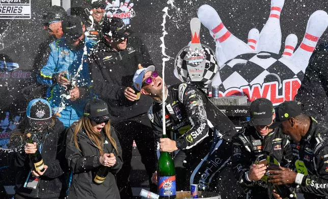 Shane Van Gisbergen, center, celebrates with his team after winning a NASCAR Cup Series auto race, Sunday, May 10, 2026, in Watkins Glen, N.Y. (Photo/Adrian Kraus)