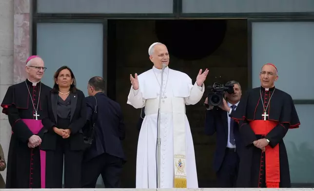 Pope Leo XIV, accompanied by, from left, Prefect of the Pontifical Household Archbishop Petar Rajič, Dean Antonella Polimeni, and his vicar for the city of Rome Cardinal Baldo Reina, visits the Città Universitaria (University City) at Sapienza University of Rome to meet with faculty and students at the institution's primary campus, one of the world's oldest and largest universities, Thursday, May 14, 2026. (AP Photo/Gregorio Borgia)