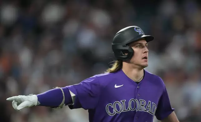 Colorado Rockies' Jake McCarthy gestures to the dugout as he heads up the first base line after hitting a two-run home run off San Francisco Giants starting pitcher Adrian Houser in the fourth inning of a baseball game Saturday, May 30, 2026, in Denver. (AP Photo/David Zalubowski)