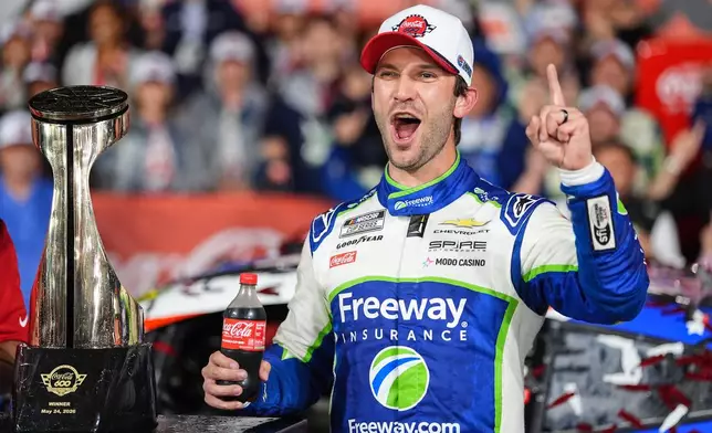 Daniel Suarez celebrates in Victory Lane after winning a NASCAR Cup Series auto race, Sunday, May 24, 2026, in Charlotte, N.C. (AP Photo/Matt Kelley)