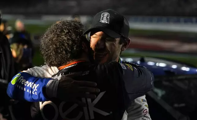 Daniel Suarez, right, is embraced by Bubba Wallace after winning a NASCAR Cup Series auto race, Sunday, May 24, 2026, in Charlotte, N.C. (AP Photo/Matt Kelley)