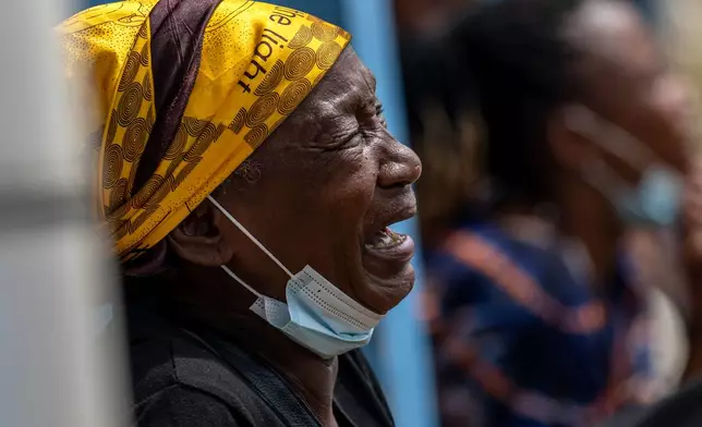 A woman mourns her child, who died of Ebola, at the General Hospital in Bunia, Congo, Thursday, May 21, 2026. (AP Photo/Moses Sawasawa)