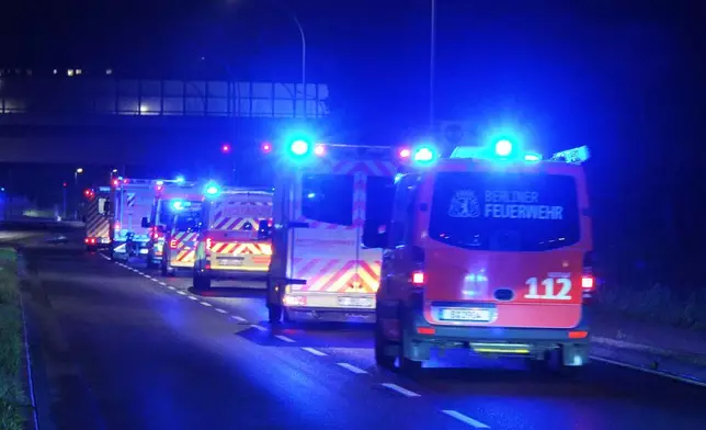 A convoy of emergency vehicles in Schönefeld, Germany, transports the family of a U.S. national who tested positive for Ebola in Congo, from the airport to where the patient is being examined in a special isolation ward of the Charite hospital in Berlin, on Wednesday, May 20, 2026. (Michael Ukas/dpa via AP)