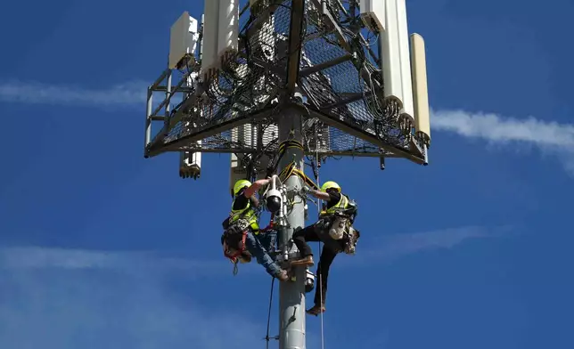 Contractors inspect Pano AI cameras used for detecting wildfires Monday, April 20, 2026, in Aurora, Colo. (AP photo/Brittany Peterson)