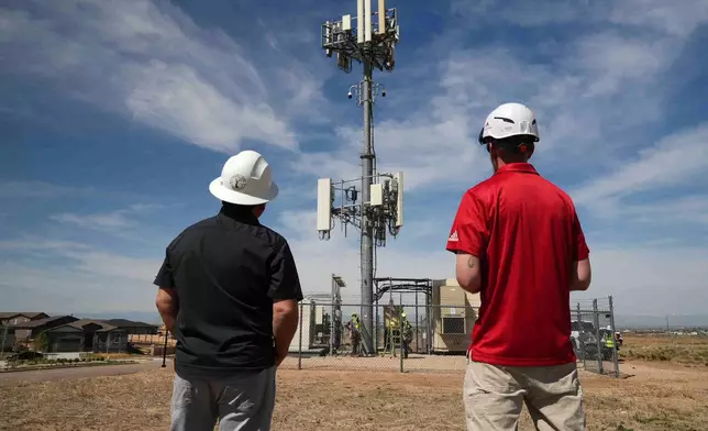 Workers observe a tower where Pano AI cameras are installed for detecting wildfires Monday, April 20, 2026, in Aurora, Colo. (AP photo/Brittany Peterson)