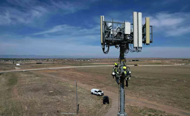 Contractors inspect Pano AI cameras used for detecting wildfires Monday, April 20, 2026, in Aurora, Colo. (AP photo/Brittany Peterson)