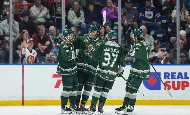 Everett Silvertips' Landon DuPont, from left, Julius Miettinen, Matias Vanhanen and Carter Bear celebrate DuPont's second goal during the second period of the Memorial Cup semifinal hockey game against the Chicoutimi Sagueneens in Kelowna, British Columbia, Friday, May 29, 2026. (Darryl Dyck/The Canadian Press via AP)