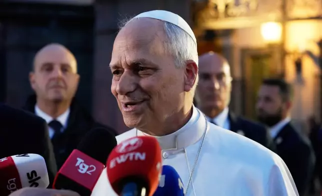 Pope Leo XIV talks to journalists as he leaves his residence in Castel Gandolfo, on the outskirts of Rome, to return to the Vatican, Tuesday, May 5, 2026. (AP Photo/Gregorio Borgia)
