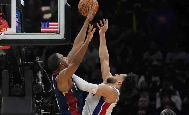 Detroit Pistons guard Cade Cunningham, right, shoots past Cleveland Cavaliers center Evan Mobley, left, in the second half of Game 6 of a second-round NBA basketball playoffs series Friday, May 15, 2026, in Cleveland. (AP Photo/Sue Ogrocki)