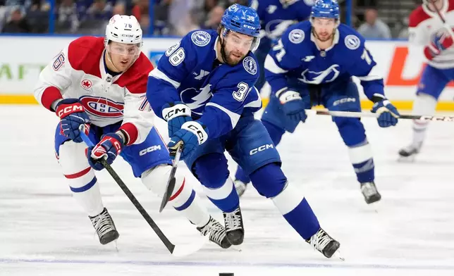 Tampa Bay Lightning left wing Brandon Hagel (38) gets around Montréal Canadiens right wing Zachary Bolduc (76) during the second period in Game 7 of an NHL hockey Stanley Cup first-round playoff series, Sunday, May 3, 2026, in Tampa, Fla. (AP Photo/Chris O'Meara)