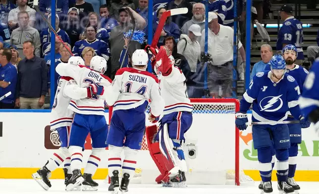 Montréal Canadiens players celebrate after the team defeated the Tampa Bay Lightning in Game 7 of an NHL hockey Stanley Cup first-round playoff series, Sunday, May 3, 2026, in Tampa, Fla. (AP Photo/Chris O'Meara)