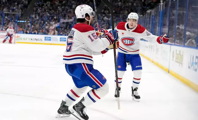 Montréal Canadiens center Alex Newhook (15) celebrates his goal against the Tampa Bay Lightning with defenseman Lane Hutson (48) during the third period in Game 7 of an NHL hockey Stanley Cup first-round playoff series, Sunday, May 3, 2026, in Tampa, Fla. (AP Photo/Chris O'Meara)