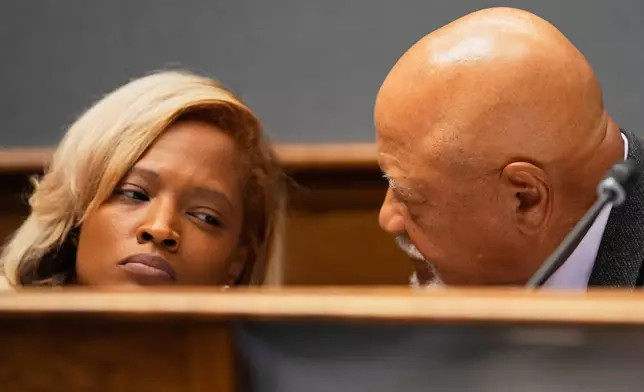 Louisiana state Rep. Wilford Carter, Sr., D-Dist. 34, talks with Rep. Joy Walters, D-Dist. 4, during a House and Governmental Affairs Committee hearing over redistricting in Baton Rouge, La., Thursday, May 21, 2026. (AP Photo/Gerald Herbert)