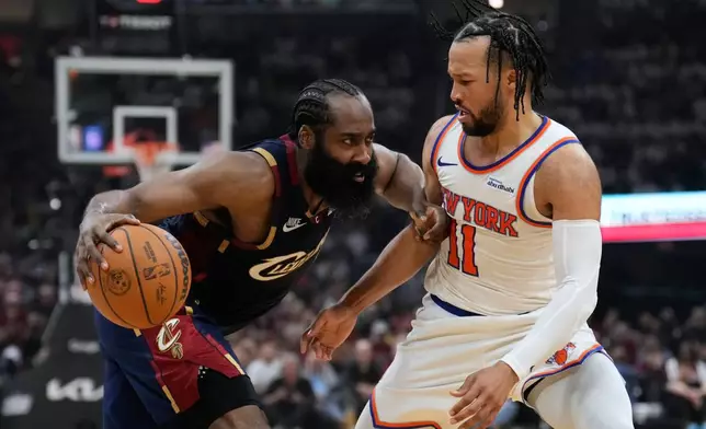 Cleveland Cavaliers guard James Harden (1) controls the ball against New York Knicks guard Jalen Brunson (11) during the second half of Game 3 in the Eastern Conference finals NBA basketball playoffs series in Cleveland, Monday, May 24, 2027. (AP Photo/Sue Ogrocki)