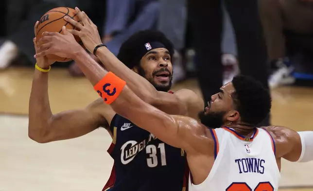 New York Knicks center Karl-Anthony Towns (32) defends against Cleveland Cavaliers center Jarrett Allen (31) during the first half of Game 3 in the Eastern Conference finals NBA basketball playoffs series in Cleveland, Saturday, May 23, 2026. (AP Photo/Tim Phillis)