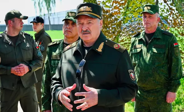 In this photo, released by Belarusian Presidential Press Service, Belarus' President Alexander Lukashenko, center, speaks to officers as he attends joint nuclear drills held by Russian and Belarusian armed forces in Asipovichy district of Belarus, Thursday, May 21, 2026. (Belarusian Presidential Press Service via AP)