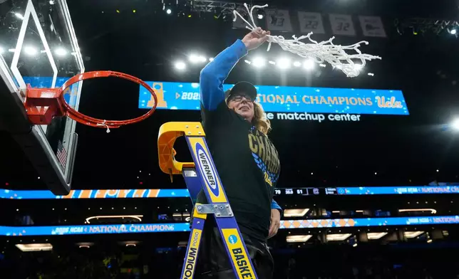 FILE - UCLA head coach Cori Close celebrates after cutting down the net after UCLA defeated South Carolina in the women's National Championship Final Four NCAA college basketball tournament game, April 5, 2026, in Phoenix. (AP Photo/Ross D. Franklin, File)