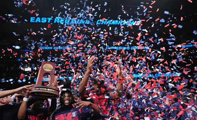 FILE - UConn players celebrate after their win against Duke in the Elite Eight of the NCAA college basketball tournament March 29, 2026, in Washington. (AP Photo/Abbie Parr, File)