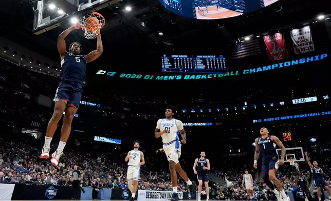 FILE - UConn forward Tarris Reed Jr. (5) dunks against Duke during the second half in the Elite Eight of the NCAA college basketball tournament on March 29, 2026, in Washington. (AP Photo/Stephanie Scarbrough, File)