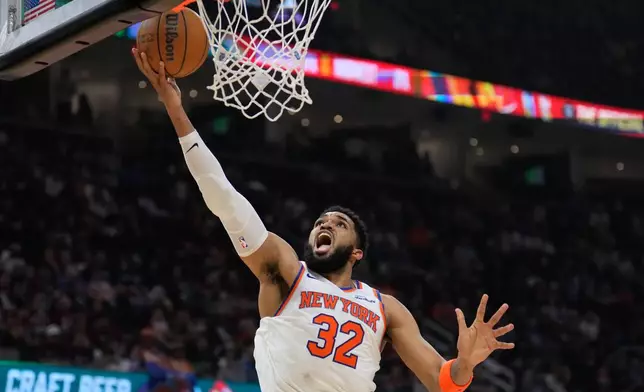 New York Knicks center Karl-Anthony Towns (32) shoots during the second half of Game 4 in the Eastern Conference finals NBA basketball playoffs series against the Cleveland Cavaliers in Cleveland, Monday, May 25, 2026. (AP Photo/Sue Ogrocki)