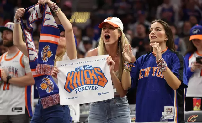 New York Knicks fans cheer during the second half of Game 4 in the Eastern Conference finals NBA basketball playoffs series against the Cleveland Cavaliers in Cleveland, Monday, May 25, 2026. (AP Photo/Tim Phillis)