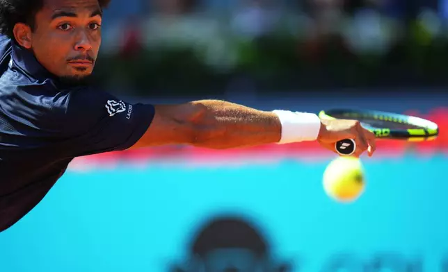France's Arthur Fils returns the ball to Italy's Jannik Sinner during their men's singles semifinal match at the Madrid Open tennis tournament in Madrid, Spain, Friday, May 1, 2026. (AP Photo/Manu Fernandez)