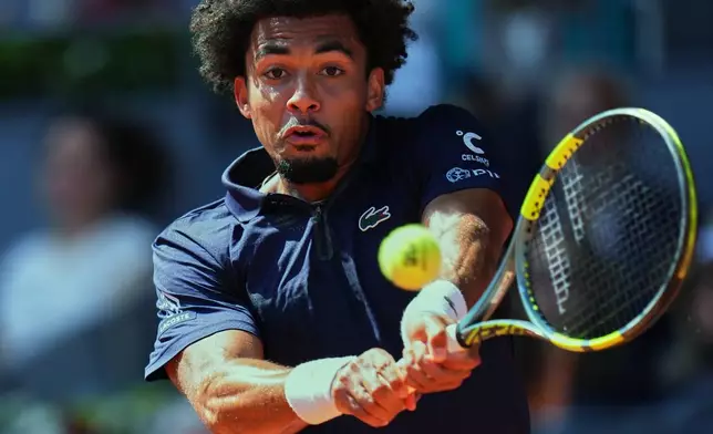 France's Arthur Fils returns the ball to Italy's Jannik Sinner during their men's singles semifinal match at the Madrid Open tennis tournament in Madrid, Spain, Friday, May 1, 2026. (AP Photo/Manu Fernandez)