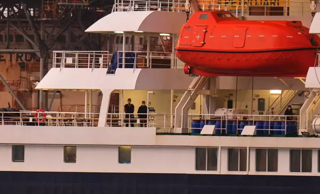 Passengers at the hantavirus-stricken cruise ship MV Hondius after arriving at the port of Granadilla in Tenerife, Canary Islands, Spain, Sunday, May 10, 2026. (AP Photo/Manu Fernandez)