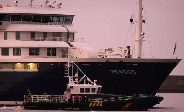 The hantavirus-stricken cruise ship MV Hondius is seen at anchor after arriving at the port of Granadilla in Tenerife, Canary Islands, Spain, Sunday, May 10, 2026. (AP Photo/Manu Fernandez)