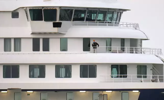 A passenger stands at the hantavirus-stricken cruise ship MV Hondius after its arrival at the port of Granadilla in Tenerife, Canary Islands, Spain, Sunday, May 10, 2026. (AP Photo/Manu Fernandez)