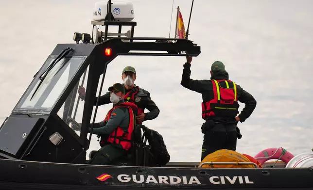 Civil Guard officers patrol next to the hantavirus-stricken cruise ship MV Hondius after its arrival at the port of Granadilla in Tenerife, Canary Islands, Spain, Sunday, May 10, 2026. (AP Photo/Manu Fernandez)